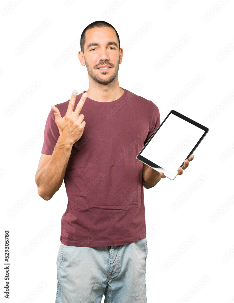Young man doing gestures using a tablet Young man doing gestures using a tablet