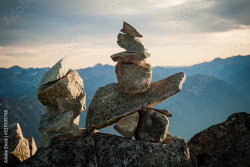 Close-up of cairn on rocks against mountains photo