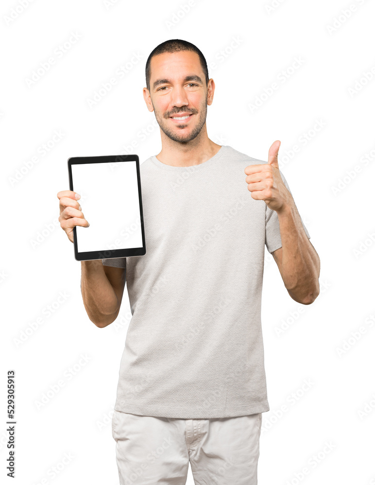 Young man doing gestures using a tablet Young man doing gestures using a tablet
