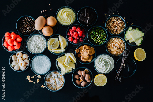 Close-up of various food in bowls over black background photo