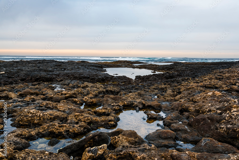 Scenic view of sea with rocky beach against sky Scenic view of sea with rocky beach against sky