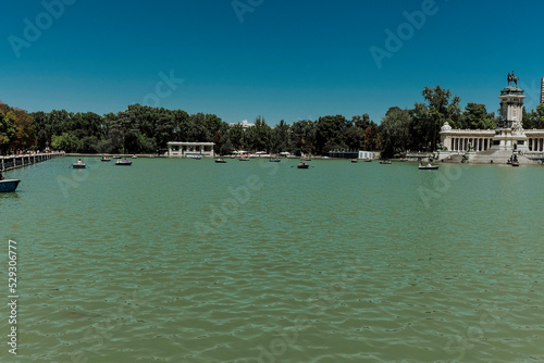 Scenic view of lake against clear blue sky at Buen Retiro Park during sunny day