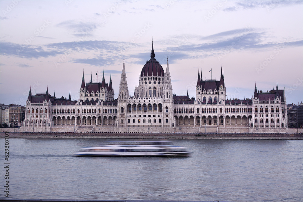 Hungarian Parliament Building by Danube River against sky during sunset Hungarian Parliament Building by Danube River against sky during sunset