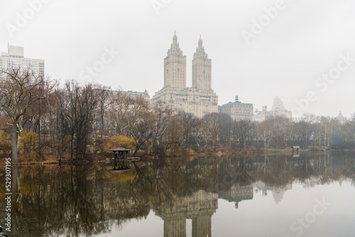 Eldorado reflecting on calm Jacqueline Kennedy Onassis Reservoir against sky during foggy weather photo
