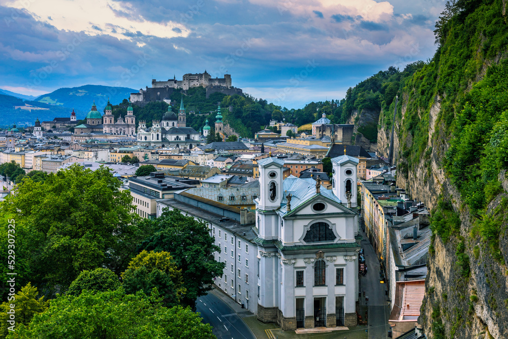 Obraz premium Beautiful view of the historic city of Salzburg with Festung Hohensalzburg in summer, Salzburger Land, Austria. Panoramic summer cityscape of Salzburg, Old City, birthplace of famed composer Mozart.