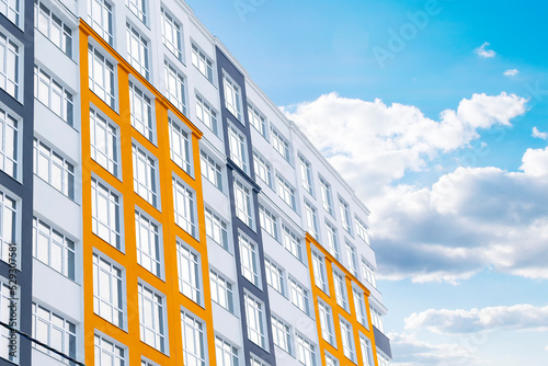 Construction complex with high rise residental apartment buildings with many windows and balconies in city residential area. Real estate development