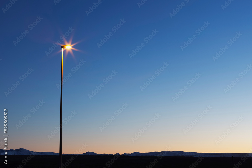 Illuminated street light against clear blue sky at night Illuminated street light against clear blue sky at night