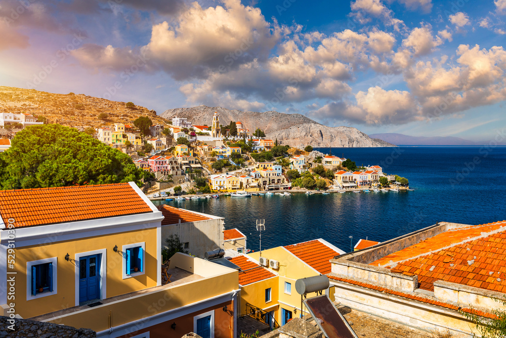 View of the beautiful greek island of Symi (Simi) with colourful houses and small boats. Greece, Symi island, view of the town of Symi (near Rhodes), Dodecanese.