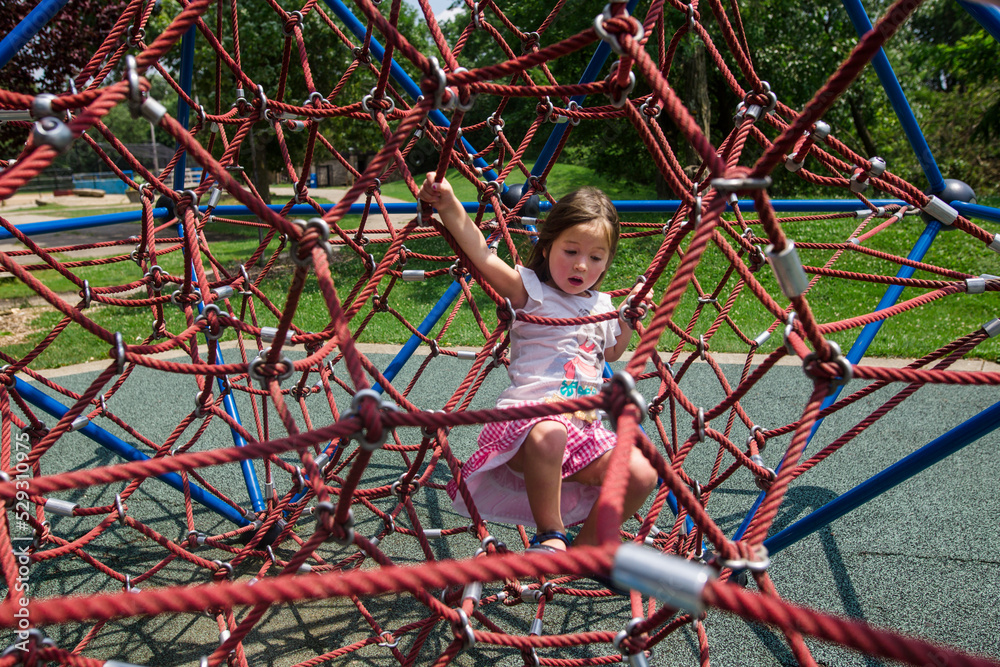 Full length of girl trapped in climbing rope net at playground Full length of girl trapped in climbing rope net at playground