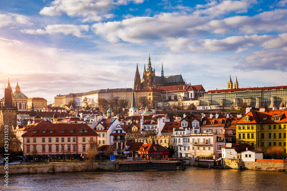 Obraz premium Prague Castle, Charles Bridge and boats on the Vltava river. View of Hradcany Prague Castle, Charles Bridge and a boats on the Vltava river in the capital of the Czechia.