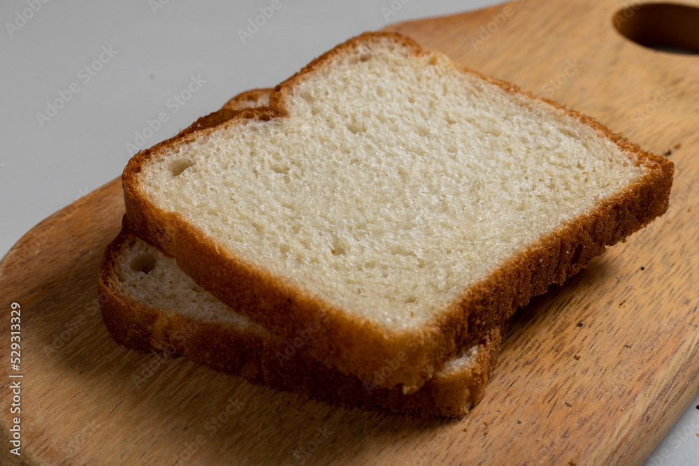 Toasted Loaf Bread with Margarine on a wood over the table