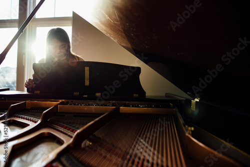 Girl playing piano while sitting at home