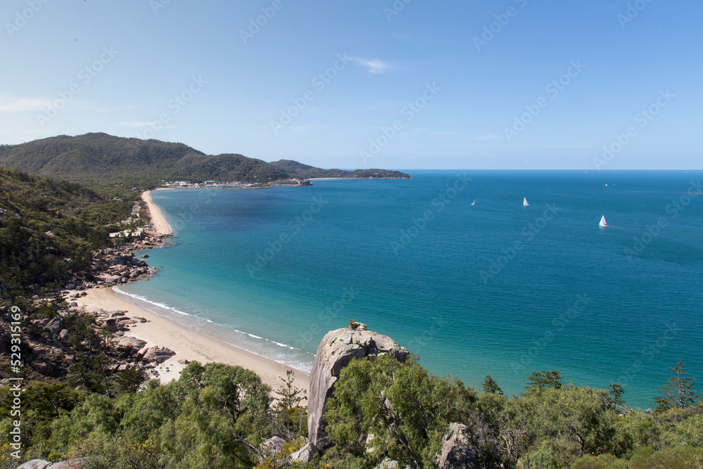 Scenic view of Magnetic Island against sky during sunny day Scenic view of Magnetic Island against sky during sunny day