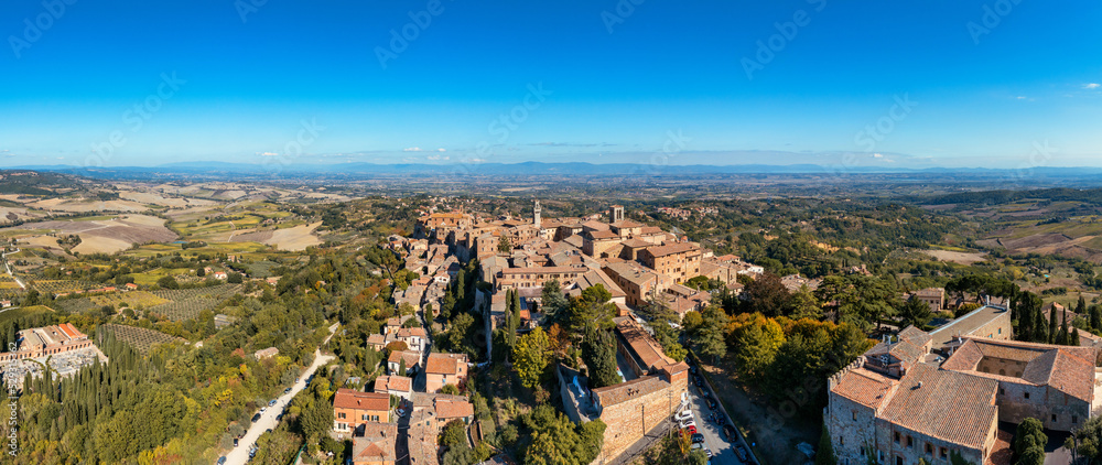 Fototapeta premium Village of Montepulciano with wonderful architecture and houses. A beautiful old town in Tuscany, Italy. Aerial view of the medieval town of Montepulciano, Italy