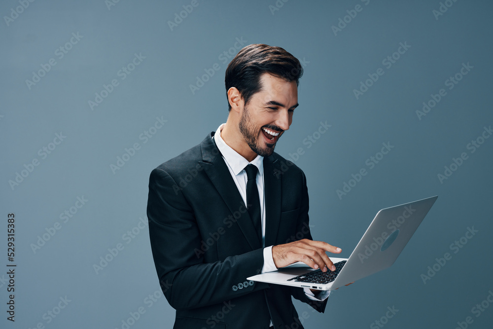 Man business with laptop pointing finger smile with teeth business talks online internet by video call on gray background. Happiness from cooperation Man business with laptop pointing finger smile with teeth business talks online internet by video call on gray background. Happiness from cooperation
