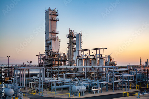 Industrial equipment against clear sky at oil refinery during sunset