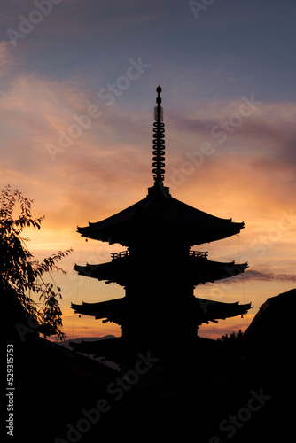 Low angle view of silhouette Buddhist temple against cloudy sky during sunset