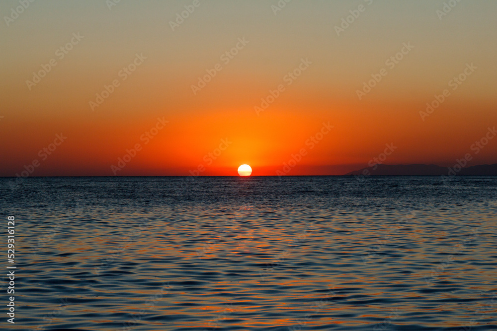 Scenic view of seascape against clear sky during sunset Scenic view of seascape against clear sky during sunset