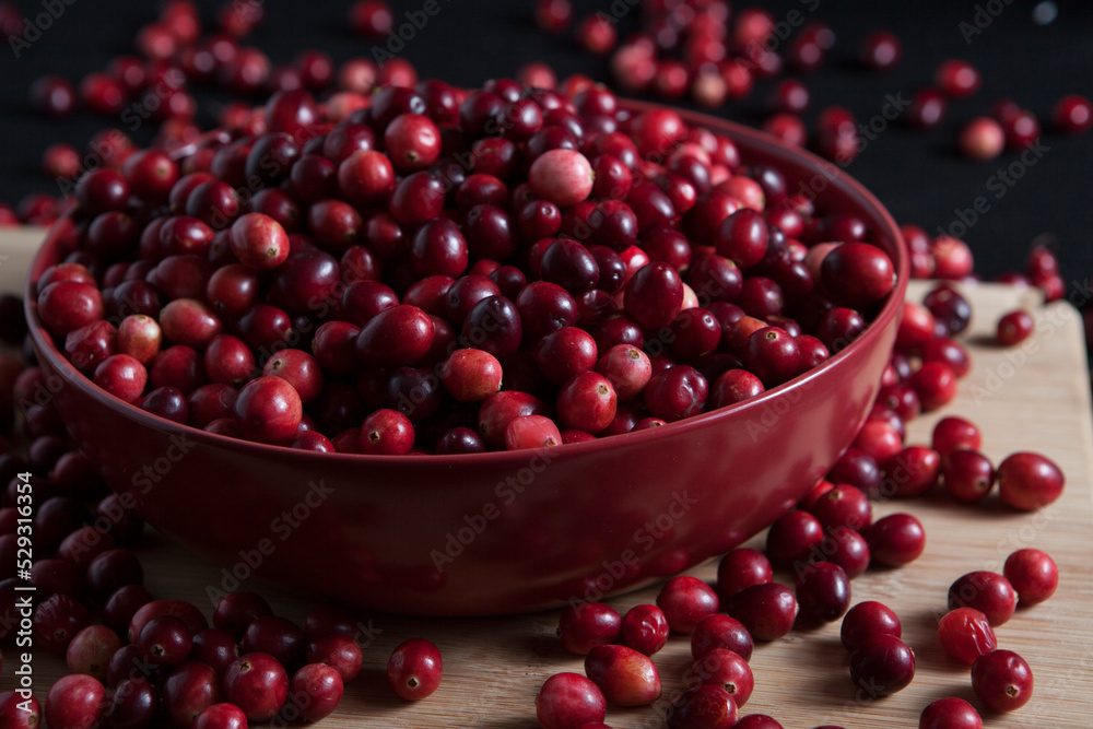 Close-up of fresh cranberries in bowl on table Close-up of fresh cranberries in bowl on table