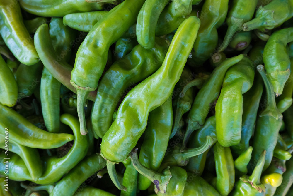 High angle view of green chili peppers for sale at market High angle view of green chili peppers for sale at market