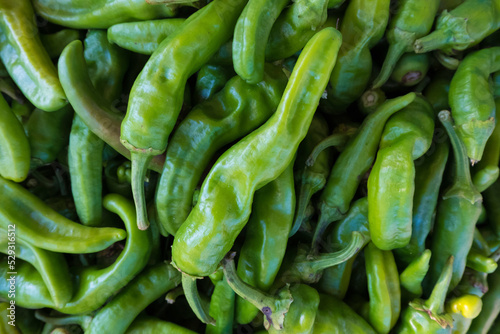 High angle view of green chili peppers for sale at market photo