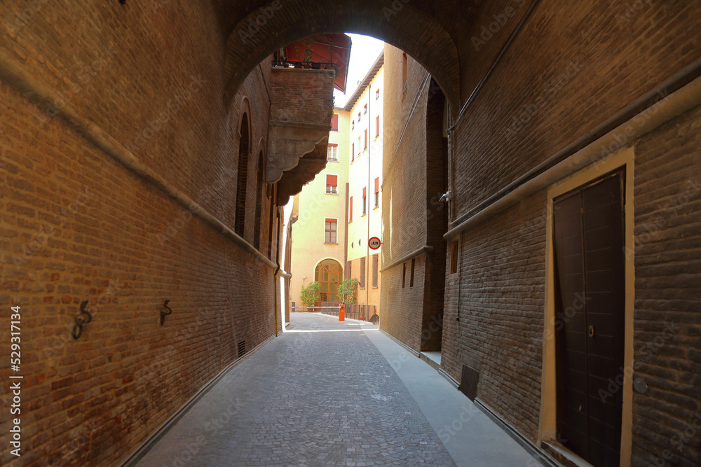 Diminishing perspective of alley amidst buildings in Bologna city Stock ...