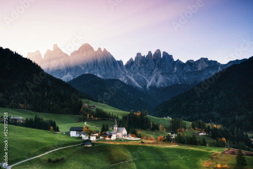 Scenic view of green landscape against sky during sunrise