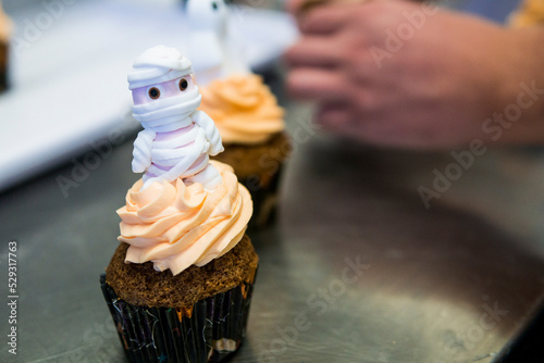 Orange cupcake with a funny soft mummy