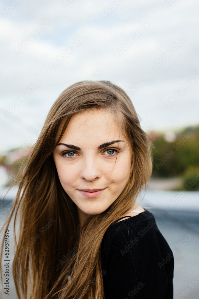 Closeup portrait of a smiling woman on the roof Closeup portrait of a smiling woman on the roof