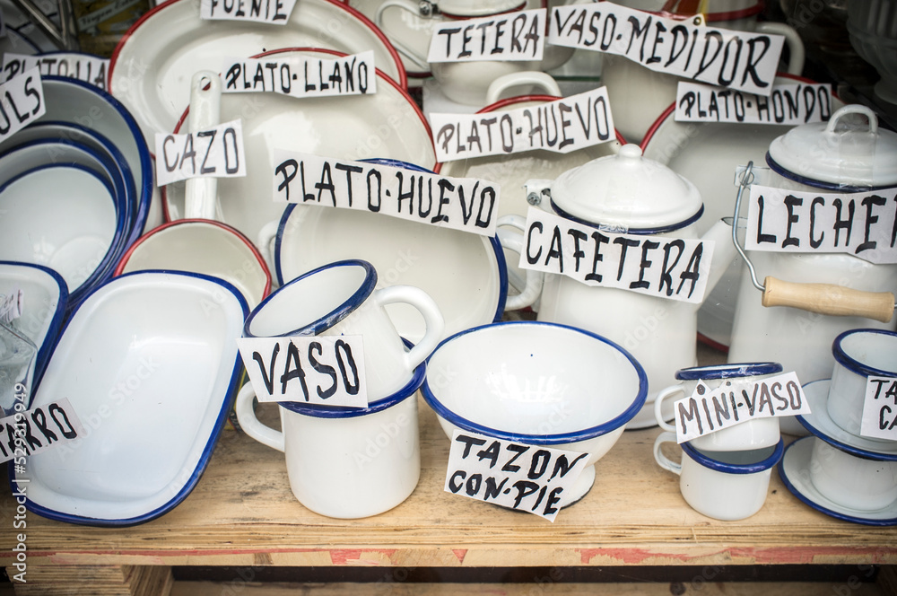 Old spanish shop offering enamel ware. Vintage white ware Stock Photo