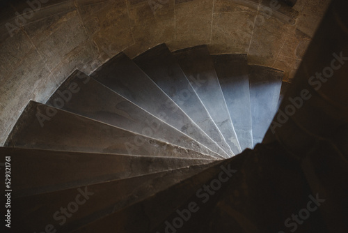looking down a spiral stairway in a castle photo