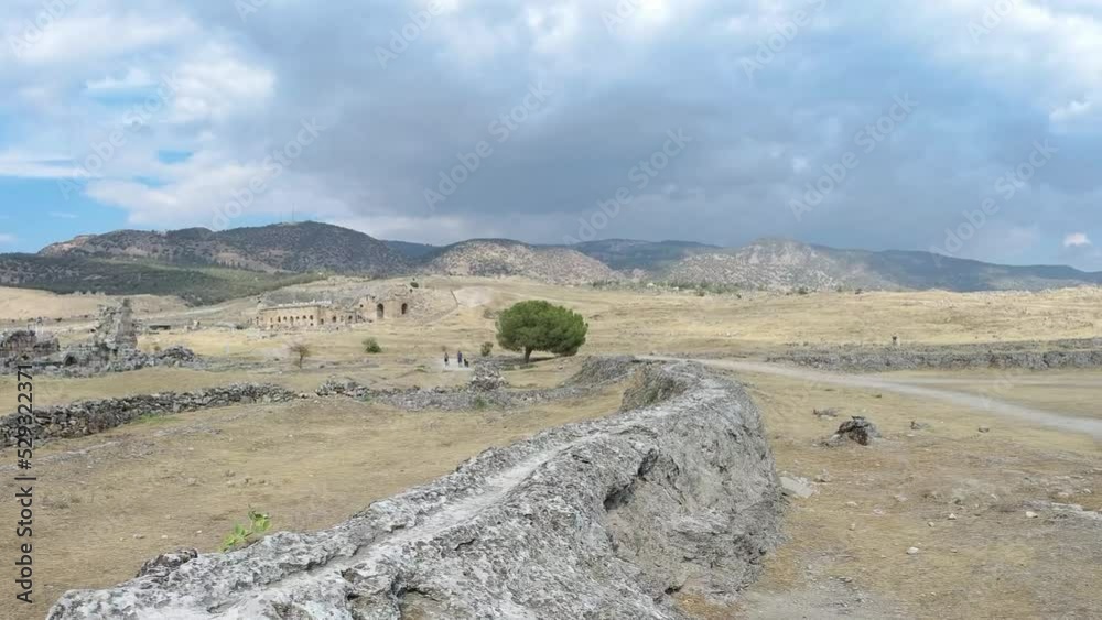 Panning shot displaying view of ancient ruins and landscape of Hierapolis, in Pamukkale, Turkey