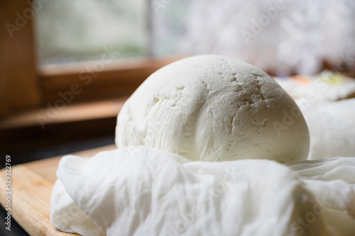 Close up of handmade goat cheese round with cheese cloth photo