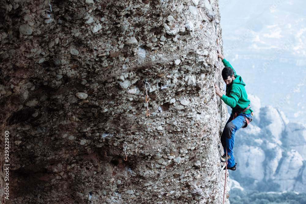 Climber sending a difficult route on sport climbing zone in Montserrat
