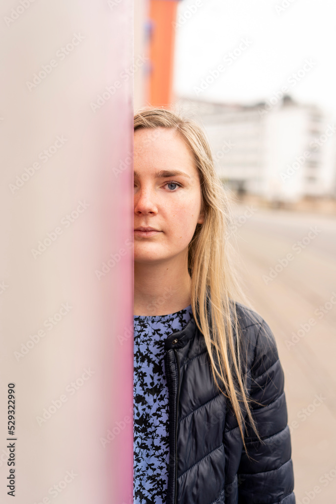 Portrait of half face of beautiful woman looking at camera in street Portrait of half face of beautiful woman looking at camera in street