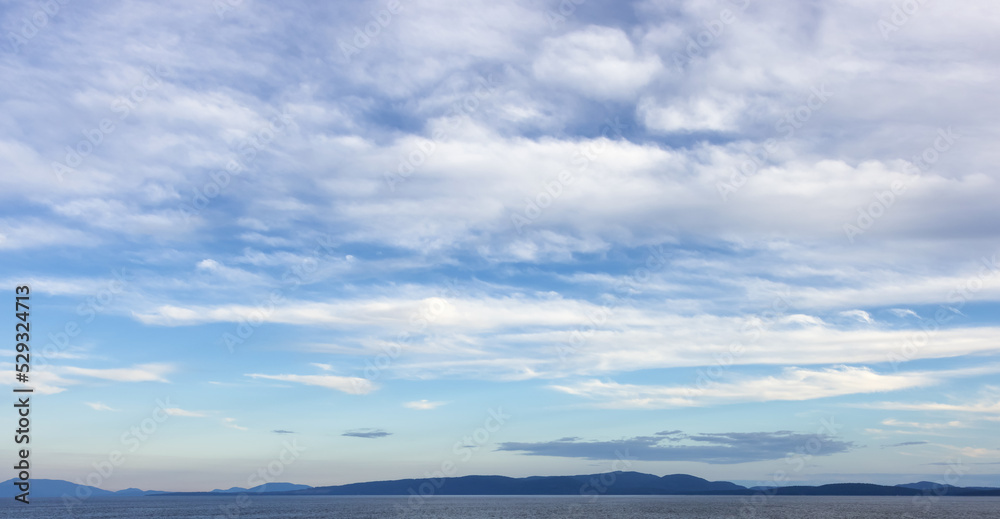Cloudy Cloudscape during sunny summer Day on the West Coast of Pacific Ocean. British Columbia, Canada. Sunset Sky