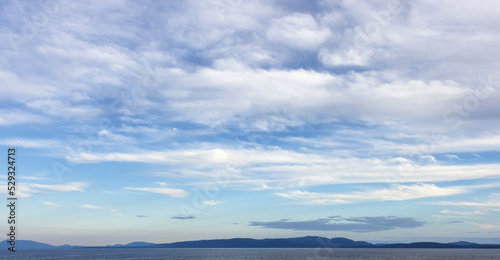 Cloudy Cloudscape during sunny summer Day on the West Coast of Pacific Ocean. British Columbia, Canada. Sunset Sky