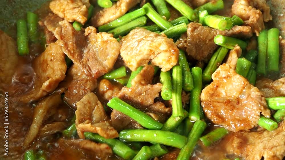 Frying chopped pork with cowpea in pan, in door Chiangmai Thailand. Frying chopped pork with cowpea in pan, in door Chiangmai Thailand.