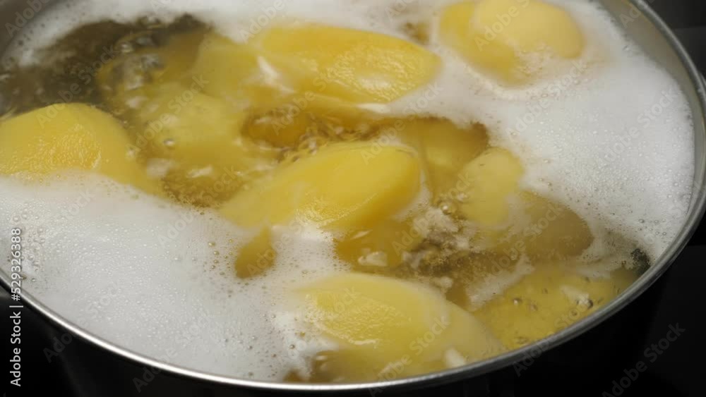 Cooking potatos in boiling water in saucepan. Closeup Cooking potatos in boiling water in saucepan. Closeup