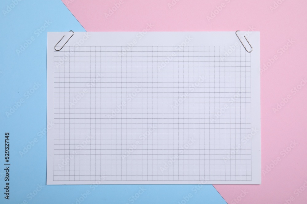 Sheet of paper with clips on color background, top view Sheet of paper with clips on color background, top view