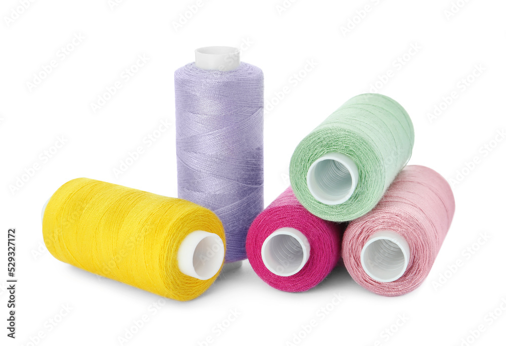 Many different colorful sewing threads on white background Many different colorful sewing threads on white background