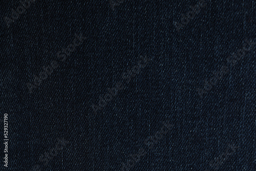 Texture of dark blue jeans as background, closeup