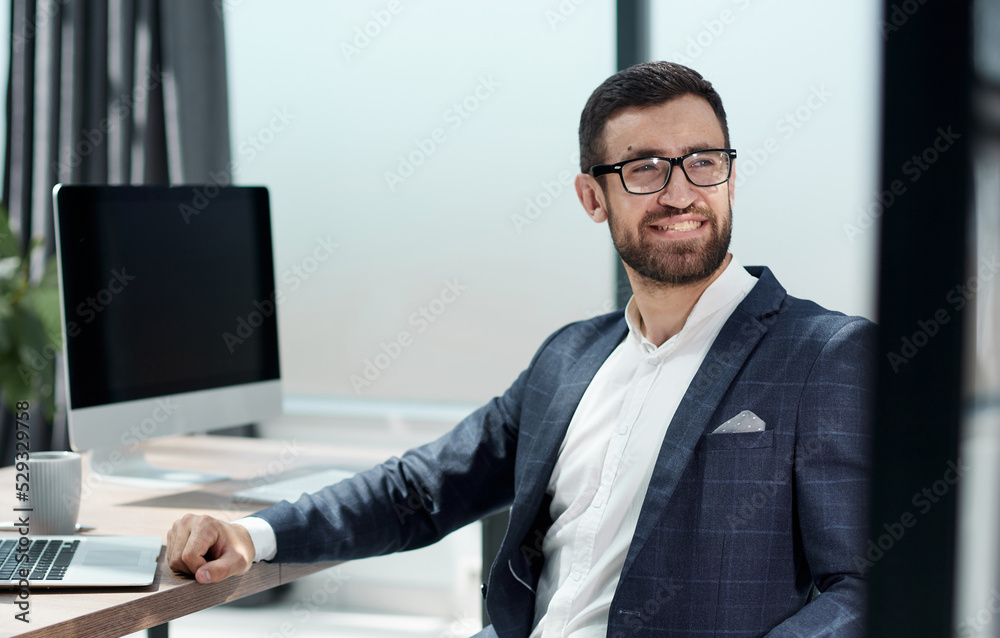 Happy entrepreneur making business plan while working on laptop at home office Happy entrepreneur making business plan while working on laptop at home office