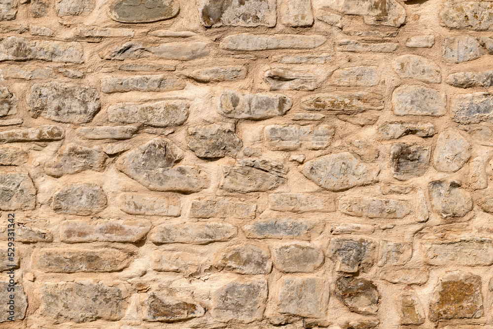 Close up of old stone wall with thick grout and rough textured surface. Close up of old stone wall with thick grout and rough textured surface.