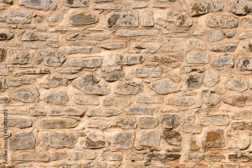 Close up of old stone wall with thick grout and rough textured surface. Close up of old stone wall with thick grout and rough textured surface.