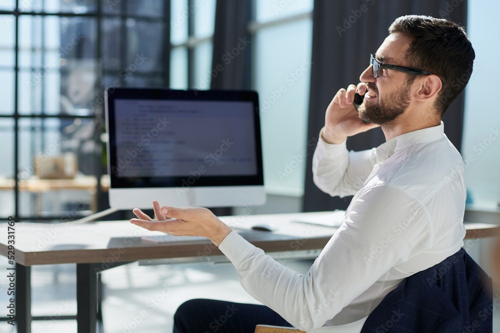 Customer care worker in an office on the telephone Customer care worker in an office on the telephone
