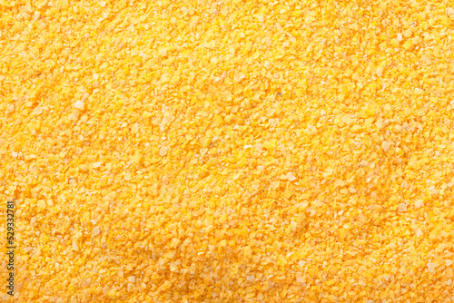 Raw cornmeal flour texture used in polenta on isolated background photo