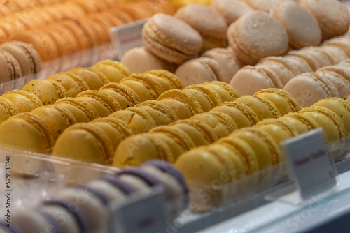 Close up view of lemon filled yellow and white macaroons at a French market