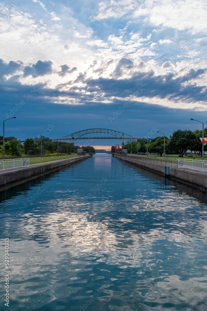 The Sault Ste. Marie Canal, running through St. Mary's River in Ontario, is seen during sunset.