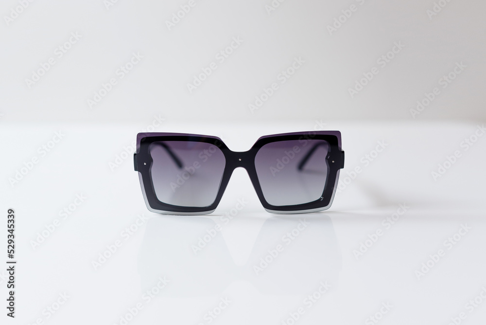 Sunglasses on white background. Flat lay, minimalistic concept of summer, vacation. Sunglasses on white background. Flat lay, minimalistic concept of summer, vacation.